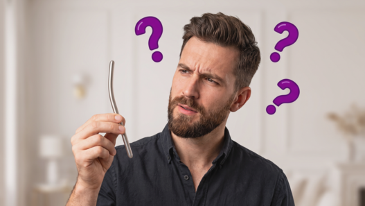 A baffled bearded man in a dark shirt holding a thin, curved silver metal object (urethral dilator), with multiple purple question marks floating around him.